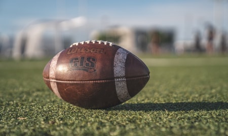 Photo of a football sitting on green turf