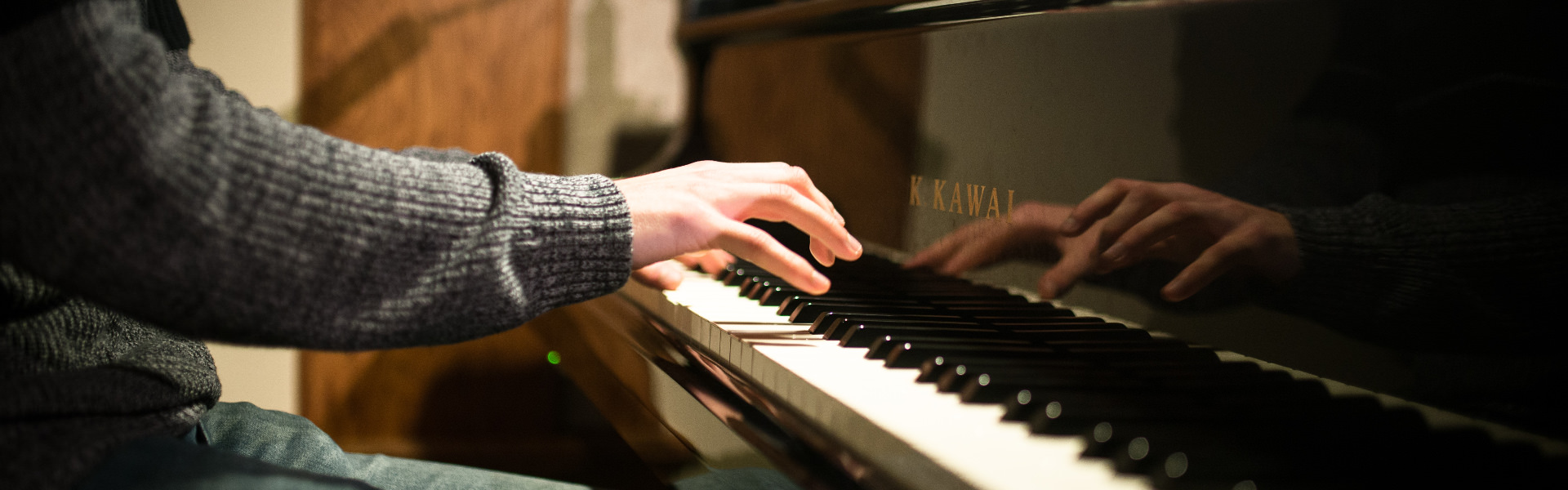 Closeup shot of a pianist playing the piano at Chapel